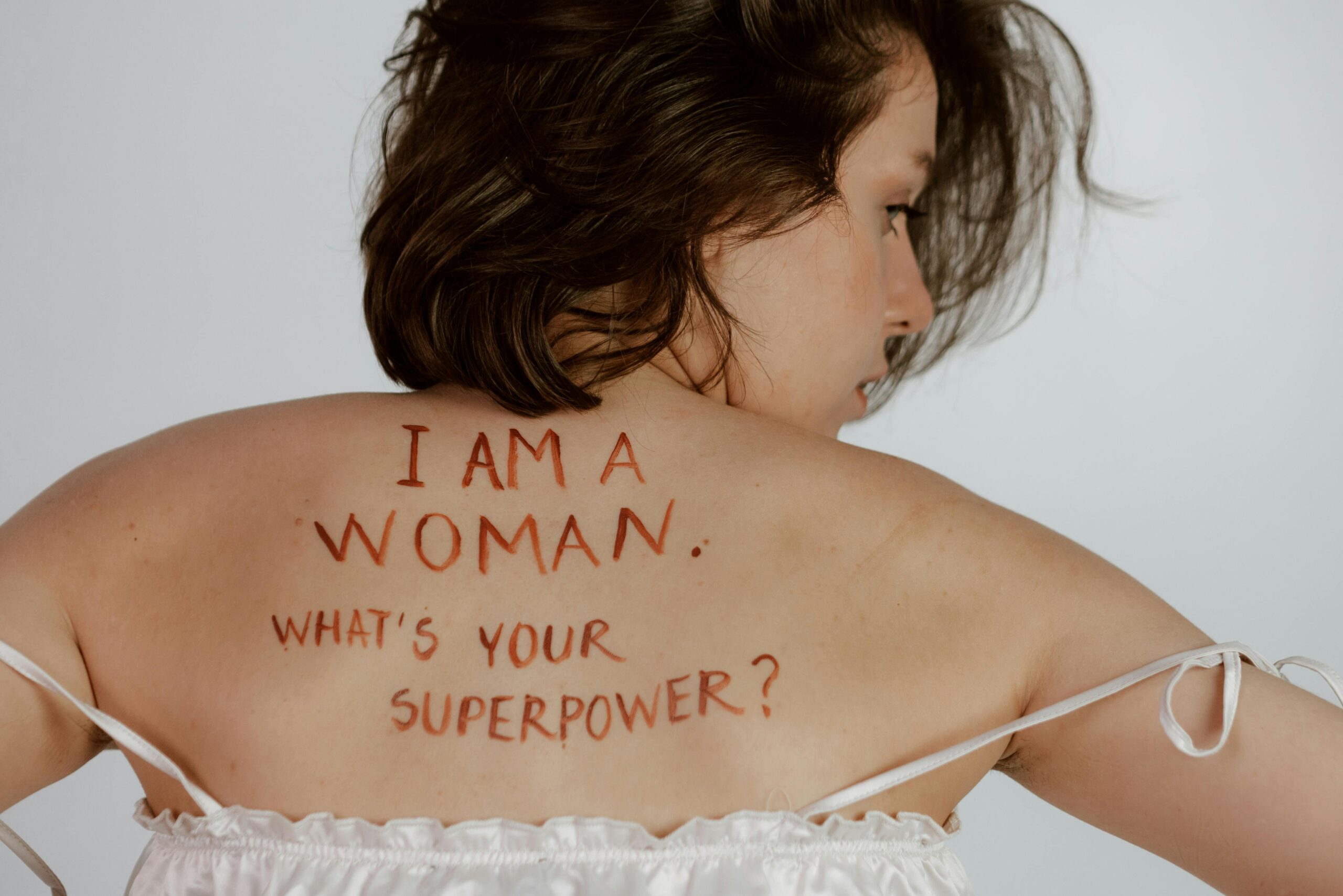 Back view of woman with empowering message, promoting self-love and feminism.